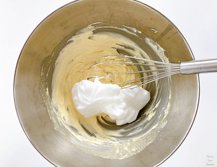 Mascarpone cream, egg whites and whisk in a bowl