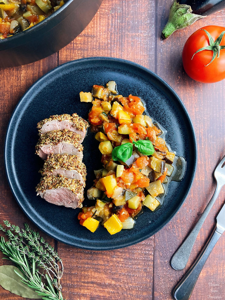 Ratatouille on a plate, pork fillet, tomato, eggplant, fork, knife, thyme, rosemary, bay leaf, ratatouille in a pot