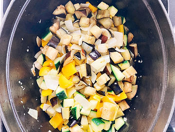 Zucchini, eggplant, yellow bell pepper, onion, and garlic in a pot