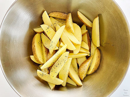 Potatoes in a bowl, olive oil, salt and pepper