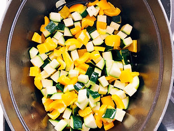 Zucchini, yellow bell pepper, and garlic in a pot