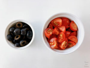 Black olives and cherry tomatoes in a container