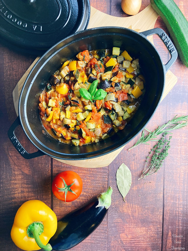 Ratatouille in a pot, pot lid, zucchini, onion, bay leaf, eggplant, yellow bell pepper, tomato, rosemary, thyme