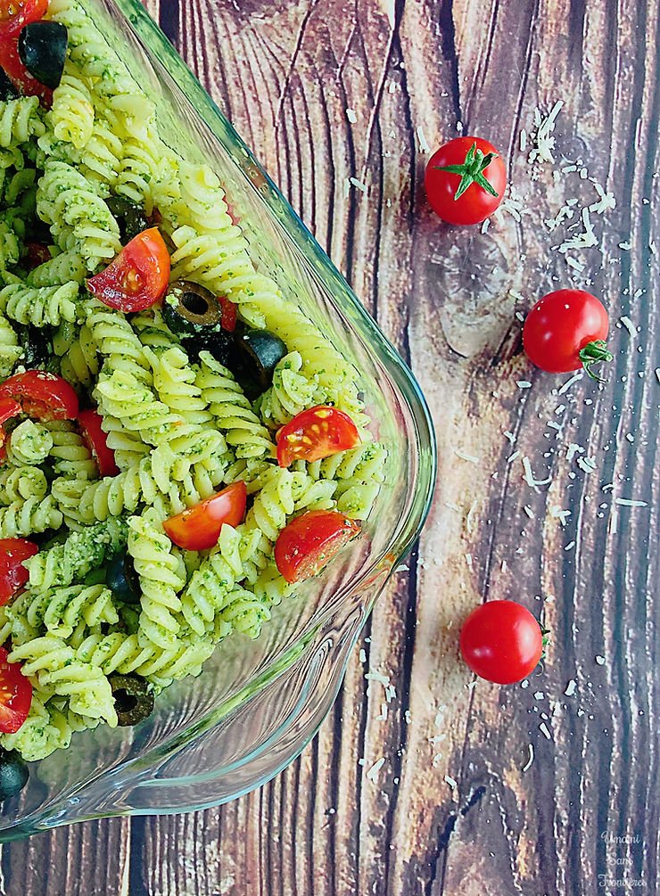 Genovese sauce pasta, tomatoes and black olives in a glass container