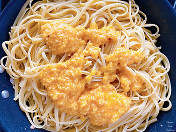 Spaghetti in a frying pan with Parmesan cheese and egg sauce