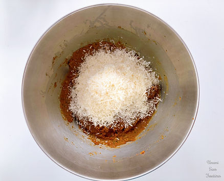 Sun-dried tomato paste and Parmesan cheese in a bowl