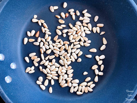 pine nuts in a frying pan