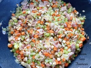 Bolognese cut vegetables and bacon in a flying pan