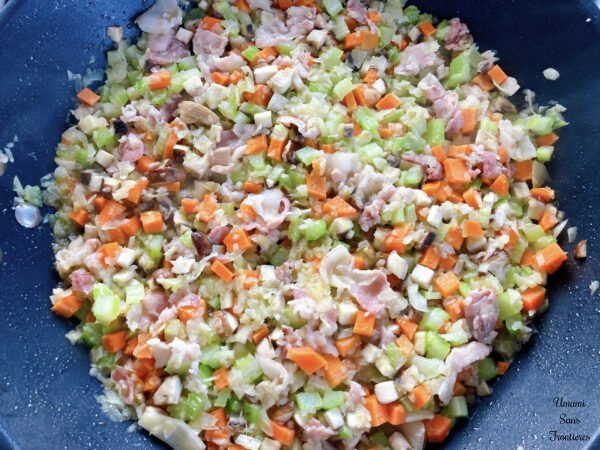 Bolognese cut vegetables and bacon in a flying pan