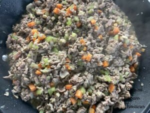 Bolognese vegetables bacon and ground meat in a flying pan