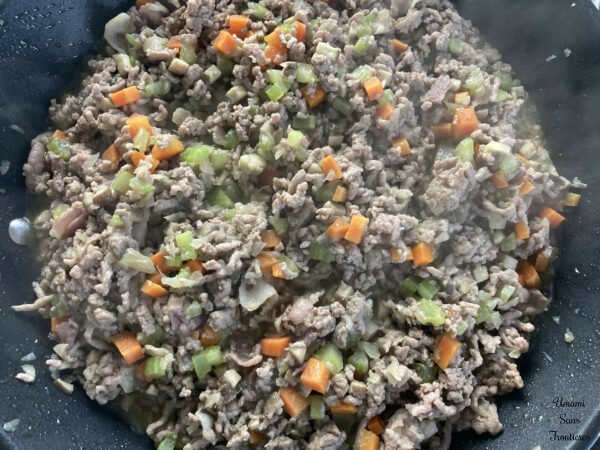Bolognese vegetables bacon and ground meat in a flying pan