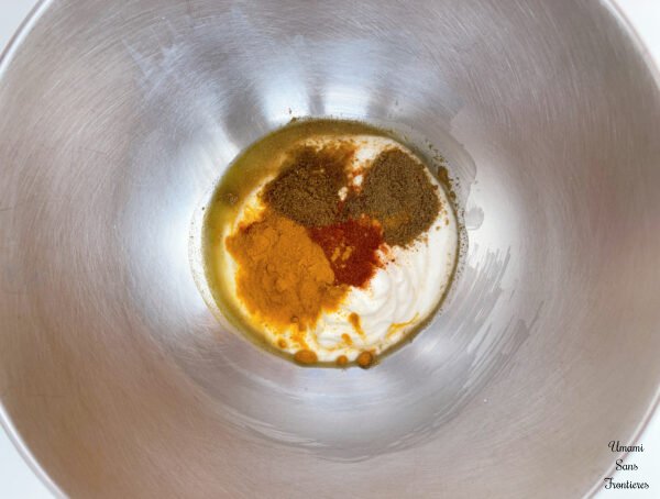 Butter chicken curry Chicken breast Plain yogurt Lemon juice Turmeric Garam masala Cumin Paprika powder ginger cloves garlic in a bowl