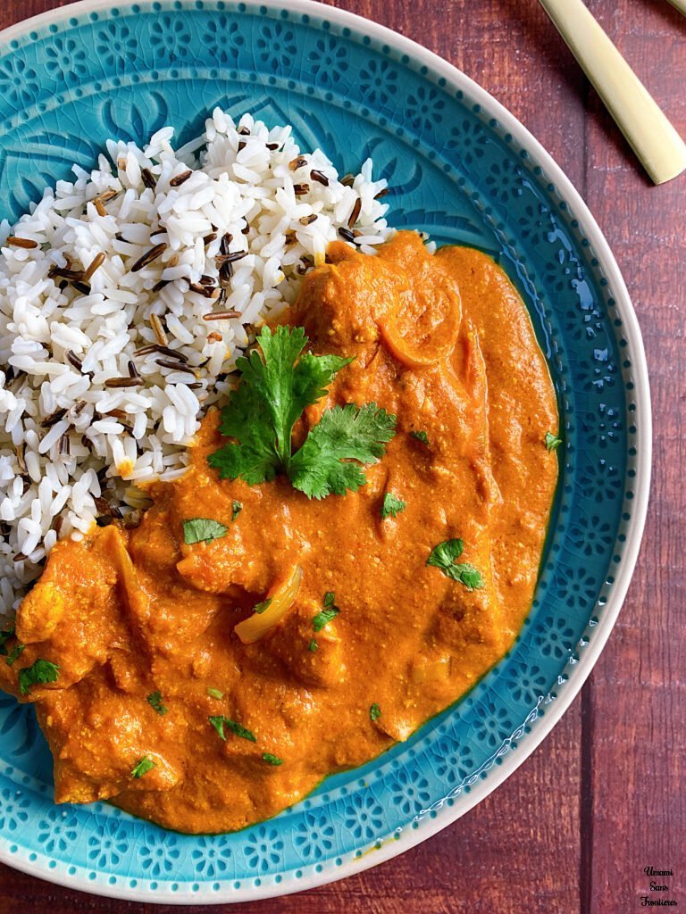 Butter chicken curry butter chicken curry coriander wild rice in a plate