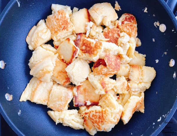 Kaiserschmarrn cut pancake in a frying pan