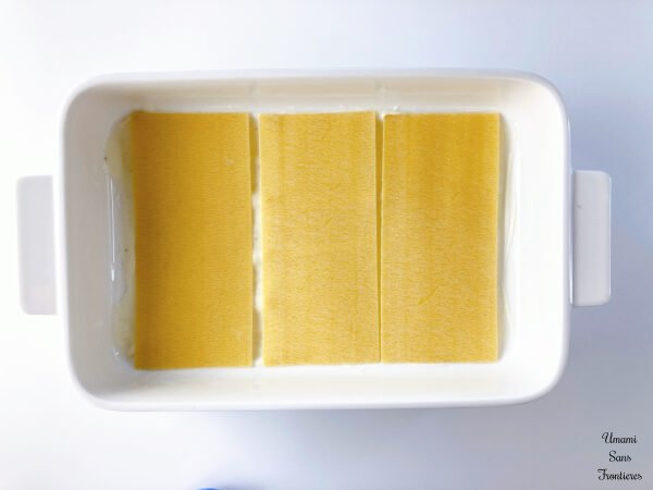Lasagne lasagne sheets on becamel sauce in a ovenproof dish