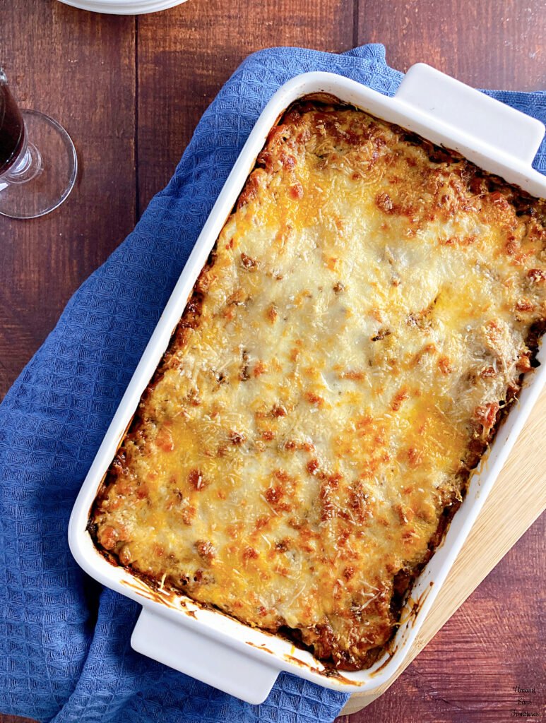 Lasagne lasagne in a ovenproof dish dish towel a red wine wine glass