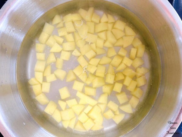 Pasta Pesto potatoes water in a pot