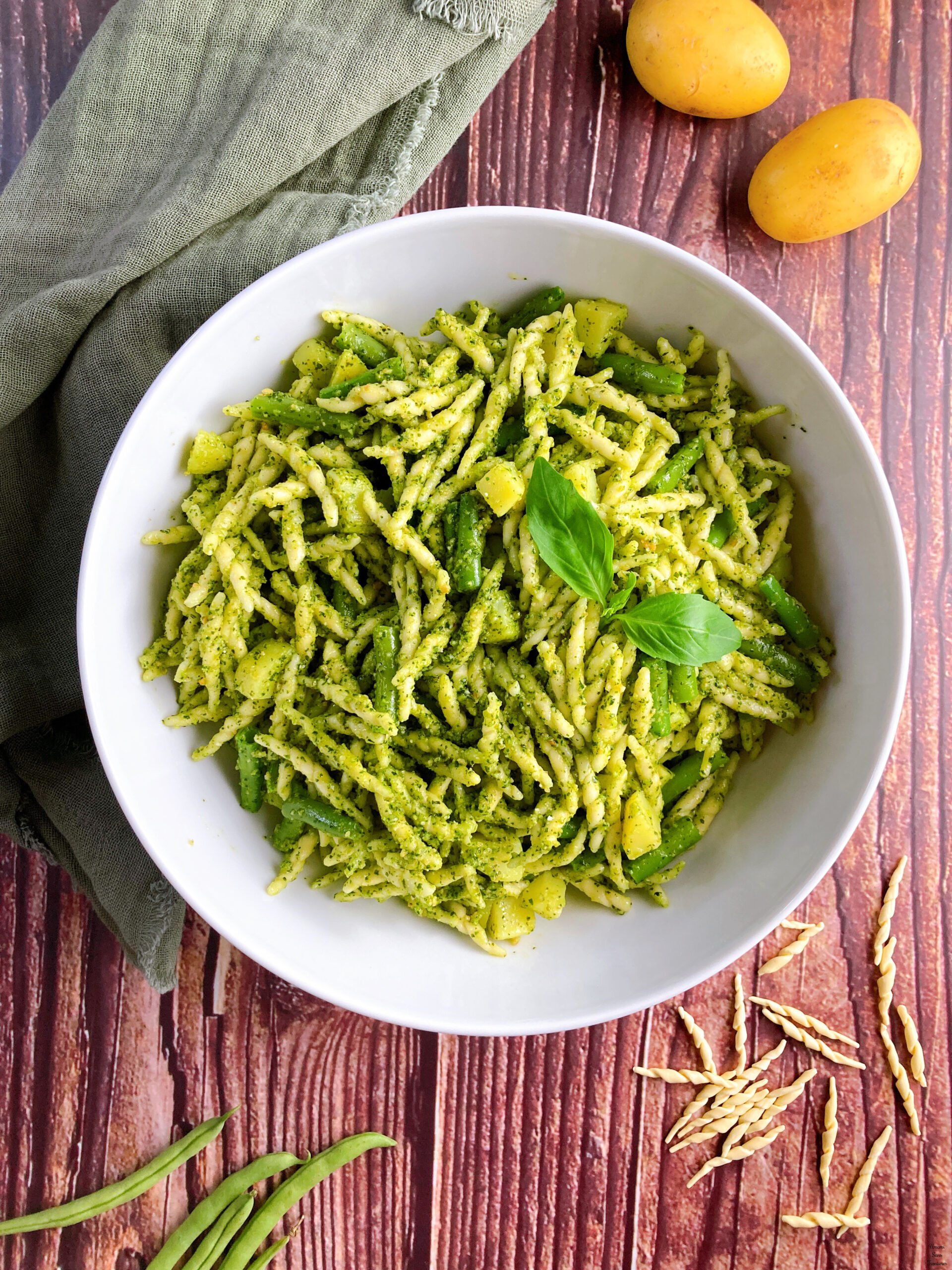 Pasta Pesto pasta with pesto potatoes and green beans basil leaves in a white bowl potatoes green beans pasta torofie