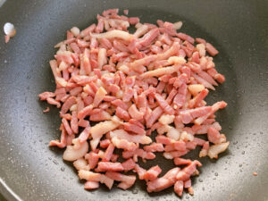 Pasta alla boscaiola cremosa saute bacon in a frying pan