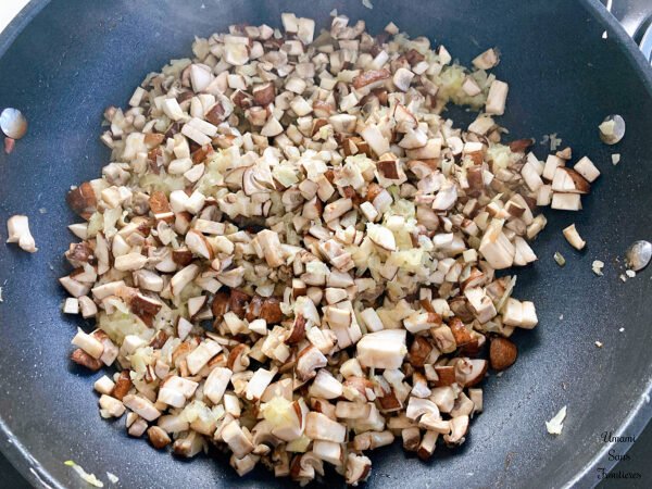 Pasta alla boscaiola cremosa mushroom onion butter in a frying pan