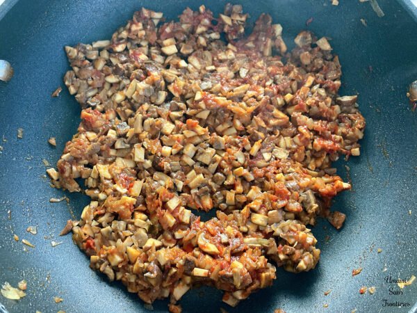 Pasta alla boscaiola cremosa mushroom onion tomato paste in a frying pan