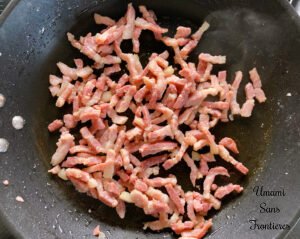 Tortellini sautéed bacon in a frying pan