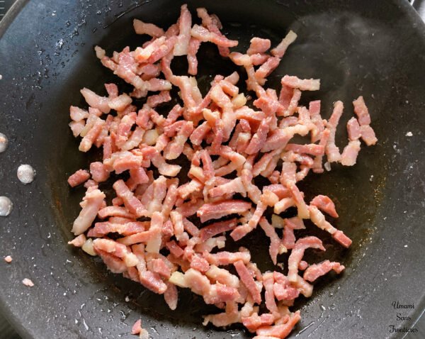 Tortellini sautéed bacon in a frying pan