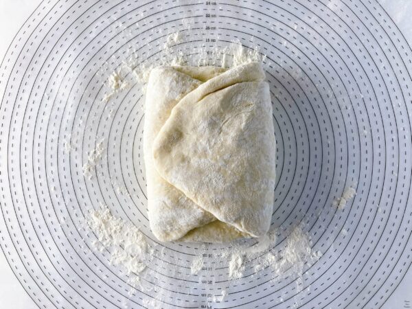 Pizza Quattro Formaggi dough folded the other side toward the center