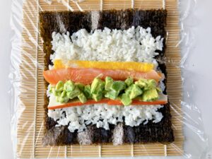 Sushi Rolls with Crab Stick, Salmon, and Avocado Sushi rice Rolled omelet Nori