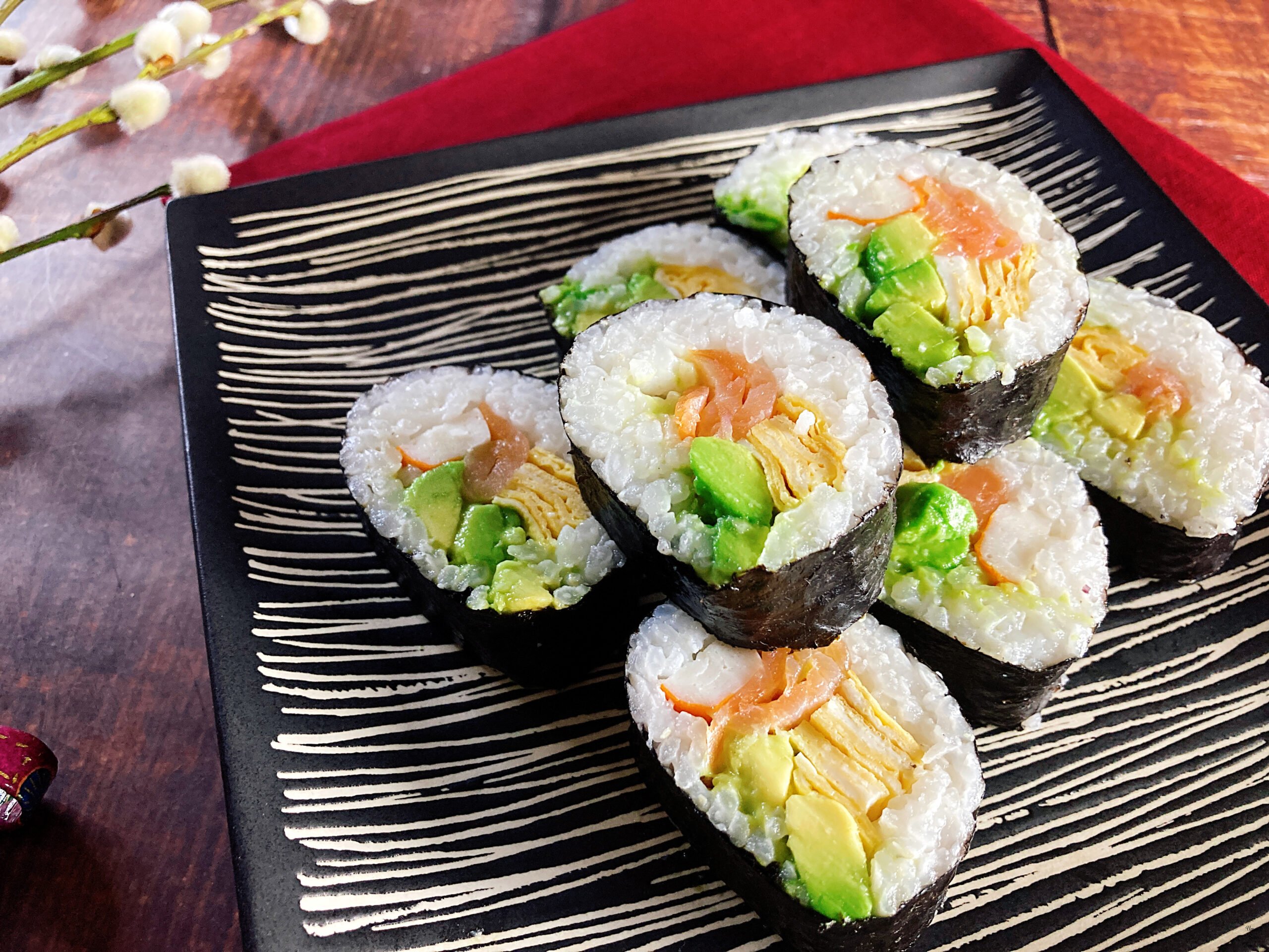 Sushi Rolls with Crab Stick, Salmon, and Avocado on the plate