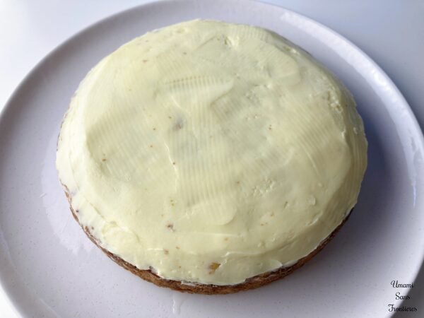 spreaded mascarpone cream on the carrot cake