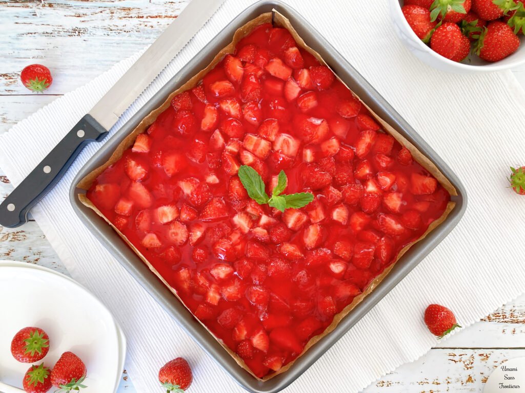 German strawberry cake in a square form cake knife strawberries