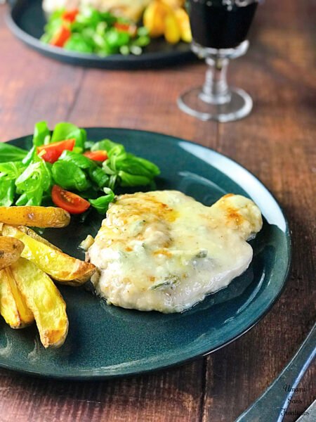 Pork steak with gorgonzola cheese sauce potatoes salade wine blue dish