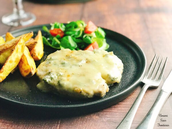 Pork steak with gorgonzola cheese sauce potatoes salad black dish