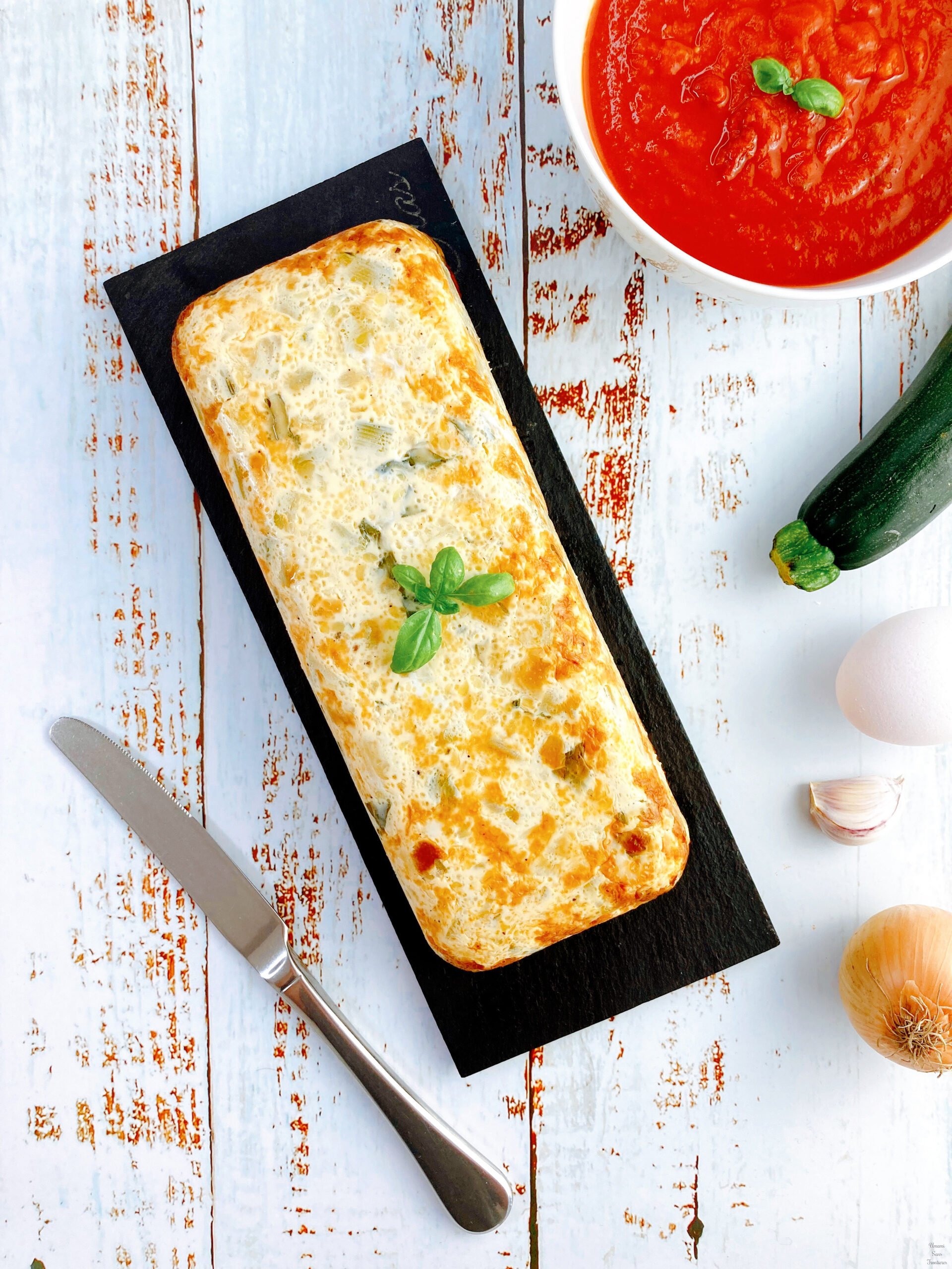 French Zucchini Flan tomato sauce zucchini egg onion garlic knife basil
