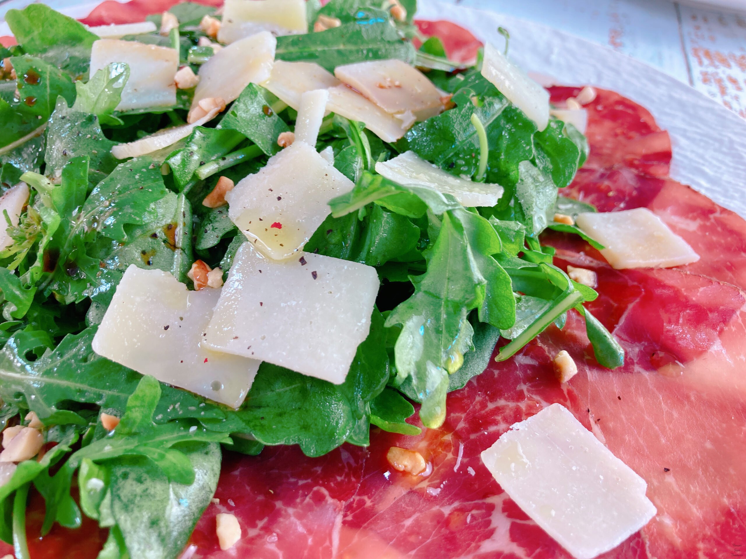 Arugula, and Grana Padano.sliced beef bresaola pepper nuts