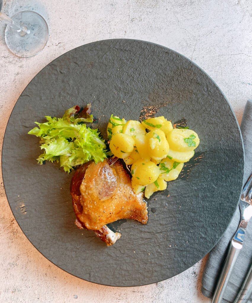 Baked duck confit sautéed potatos salad fork 