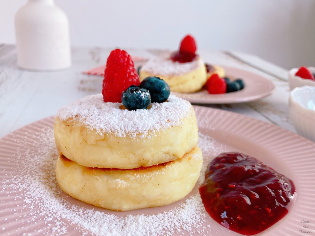 Syrniki jam powder sugar rasberry blueberries