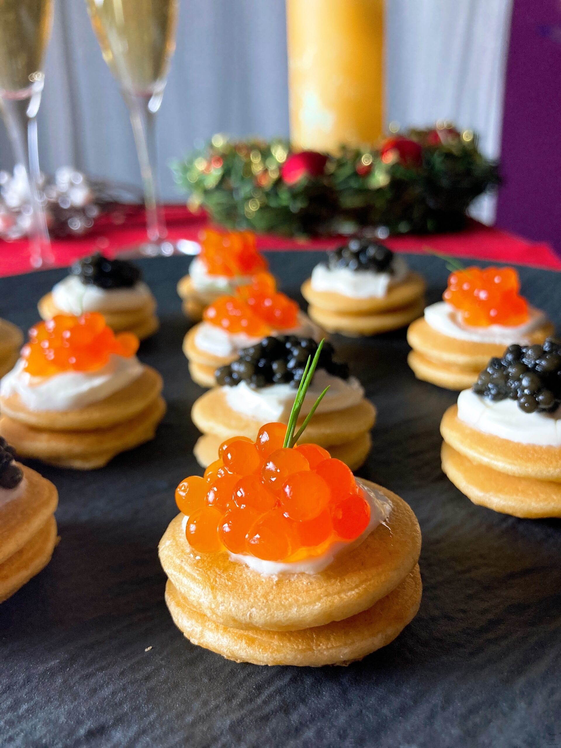 French blini caviar dill glasses of champage candle
