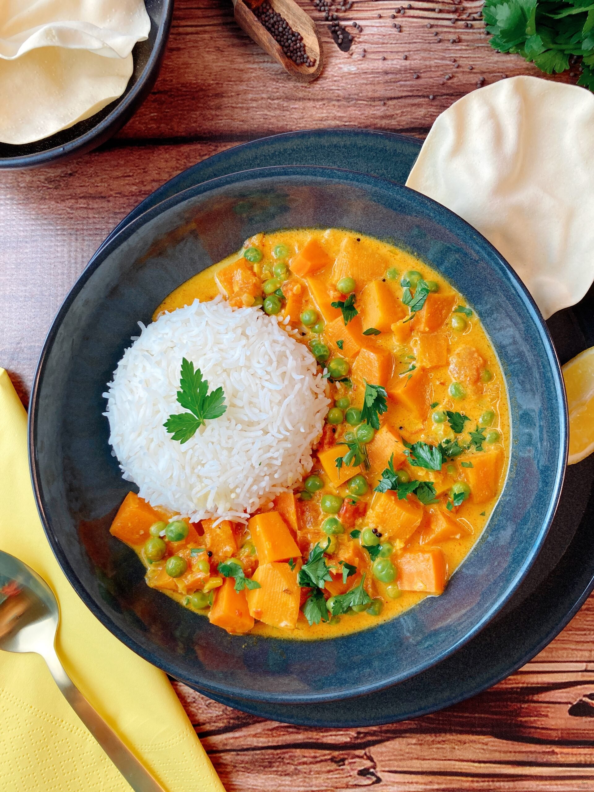 South Indian sweet potato curry pappadam lemon spoon rice parsley black mustard seeds