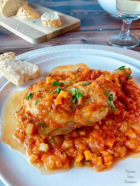 italien chicken tomato sauce on the white plate bread white wine