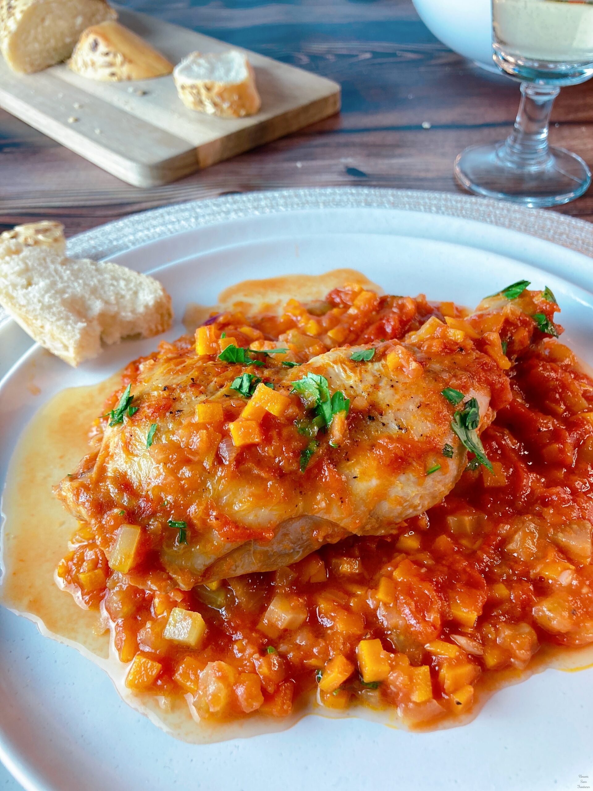 italien chicken tomato sauce on the white plate bread white wine