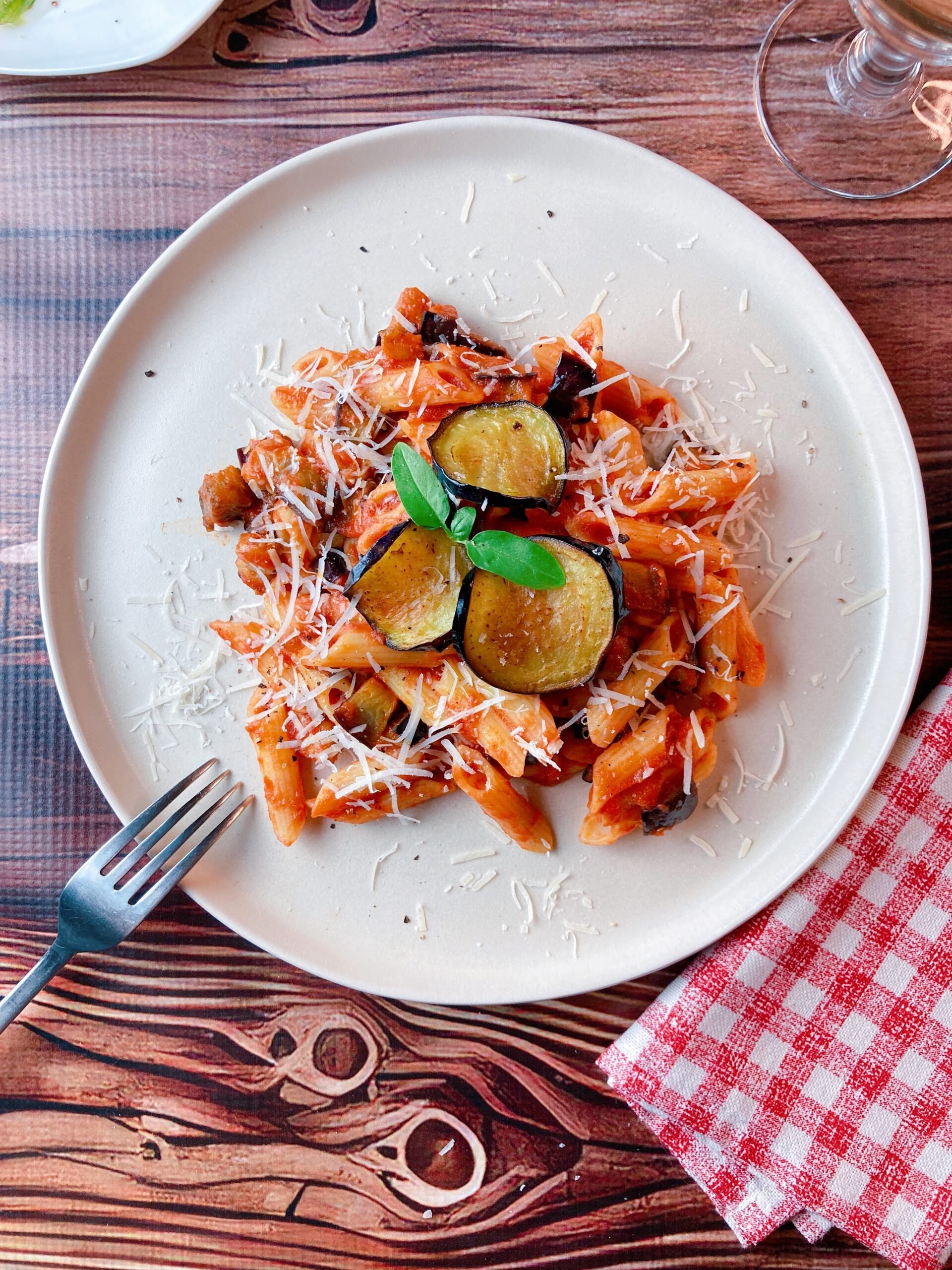 Eggplant Tomato Pasta fork white wine napkin