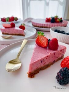 Piece of strawberry and berry cheese cake spoon