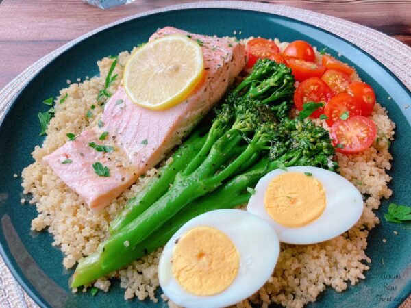 porched salmon and quinoa plate with lemon soy sauce