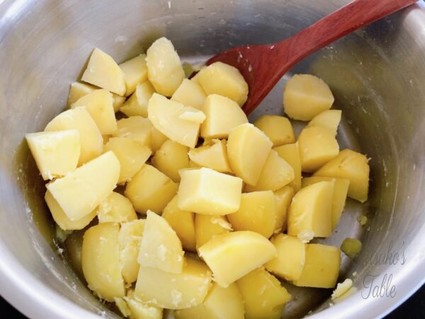 cut potato in a pot