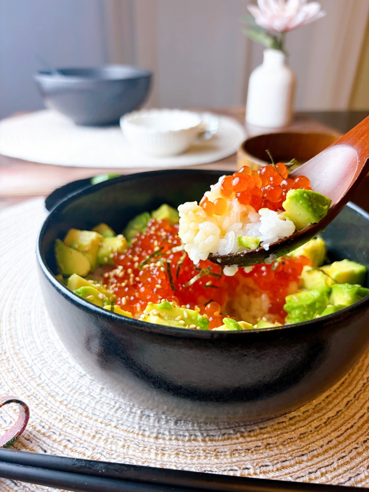 Salmon Roe & Avocado Rice Bowl rice ikura avocado on the wood spoon